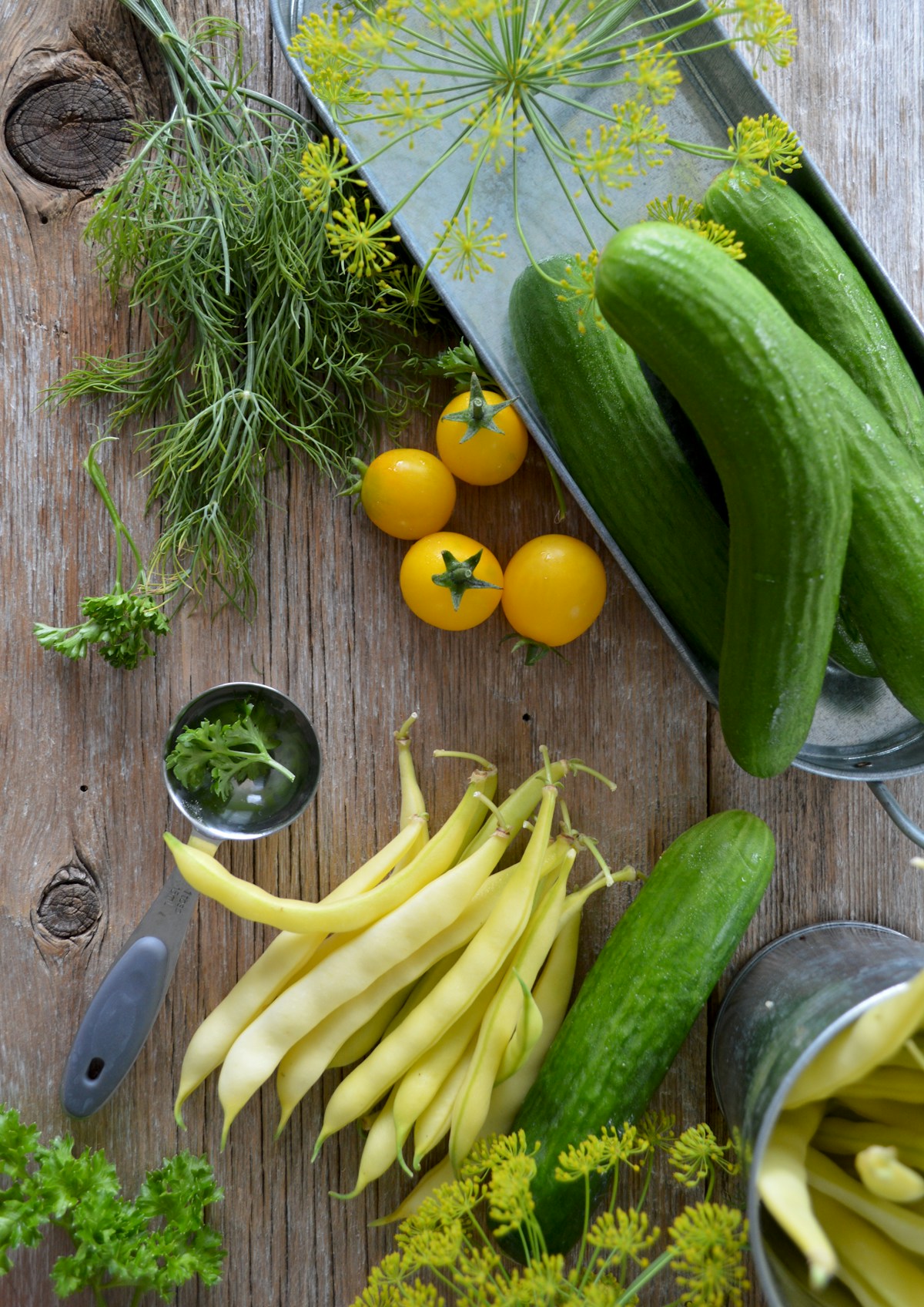 Fresh vegetables and herbs on a wooden table — representative stock photograph
