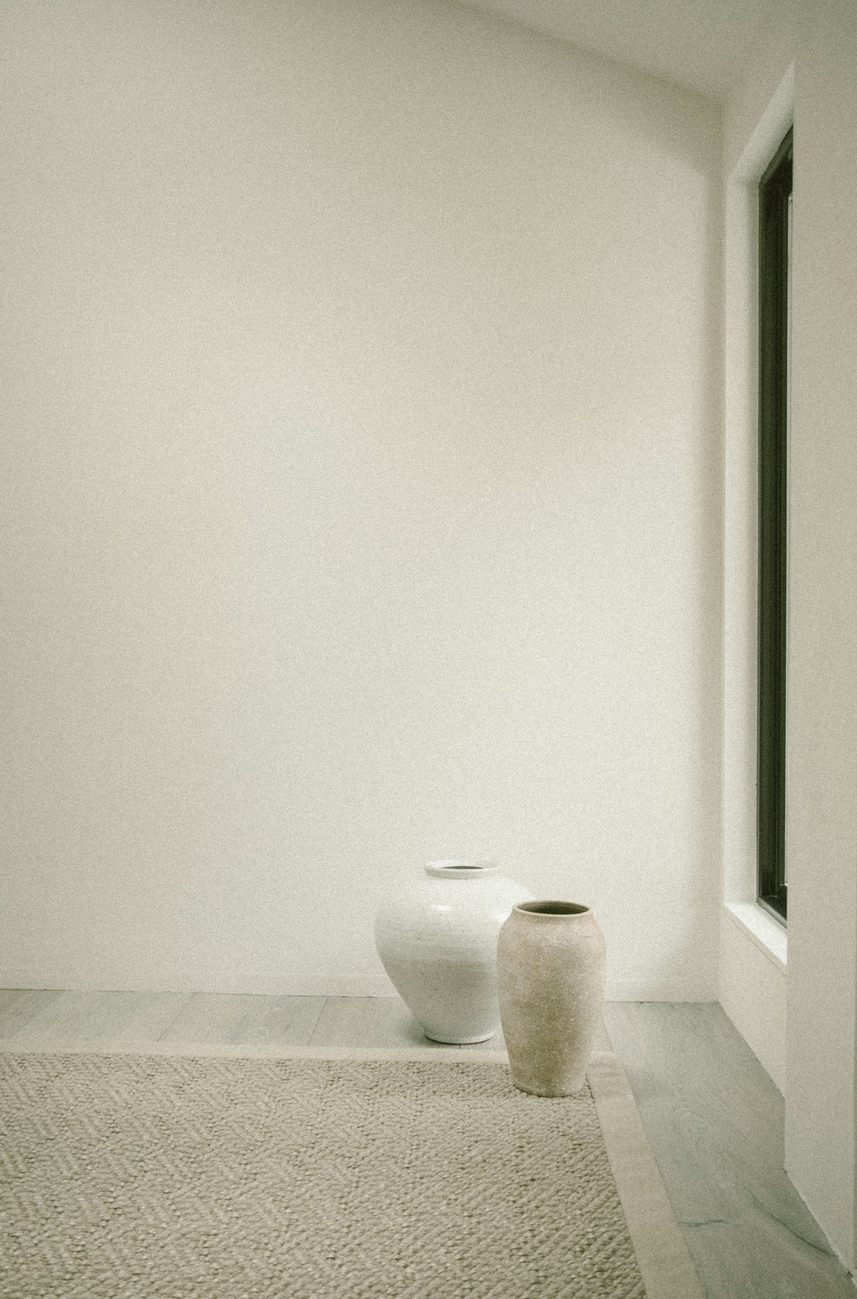 Ceramic vases beside a window — representative stock photograph