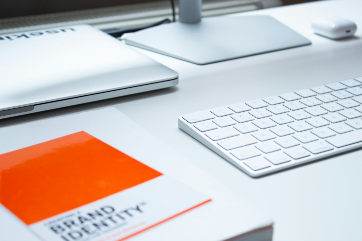 A keyboard and notebook on a real desk — representative stock photograph