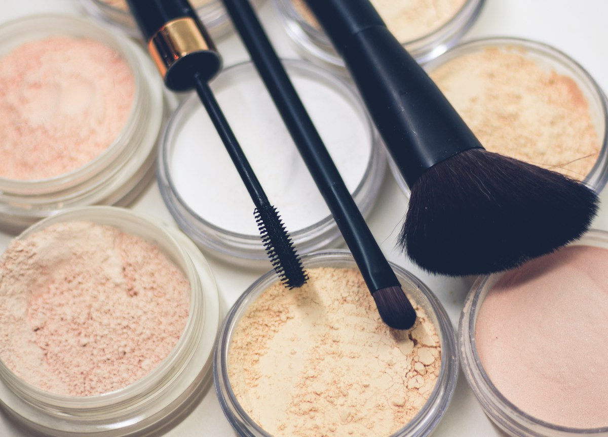 Makeup brushes and powder palettes — representative stock photograph